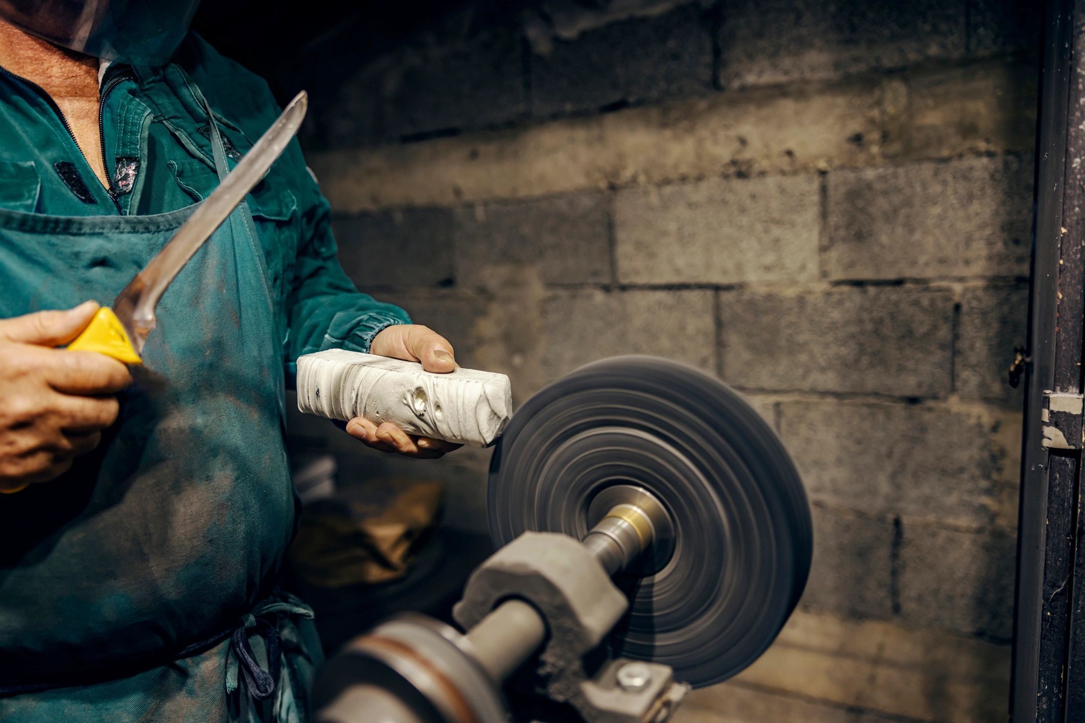 Craftsperson hands working in a workshop, representing skilled production