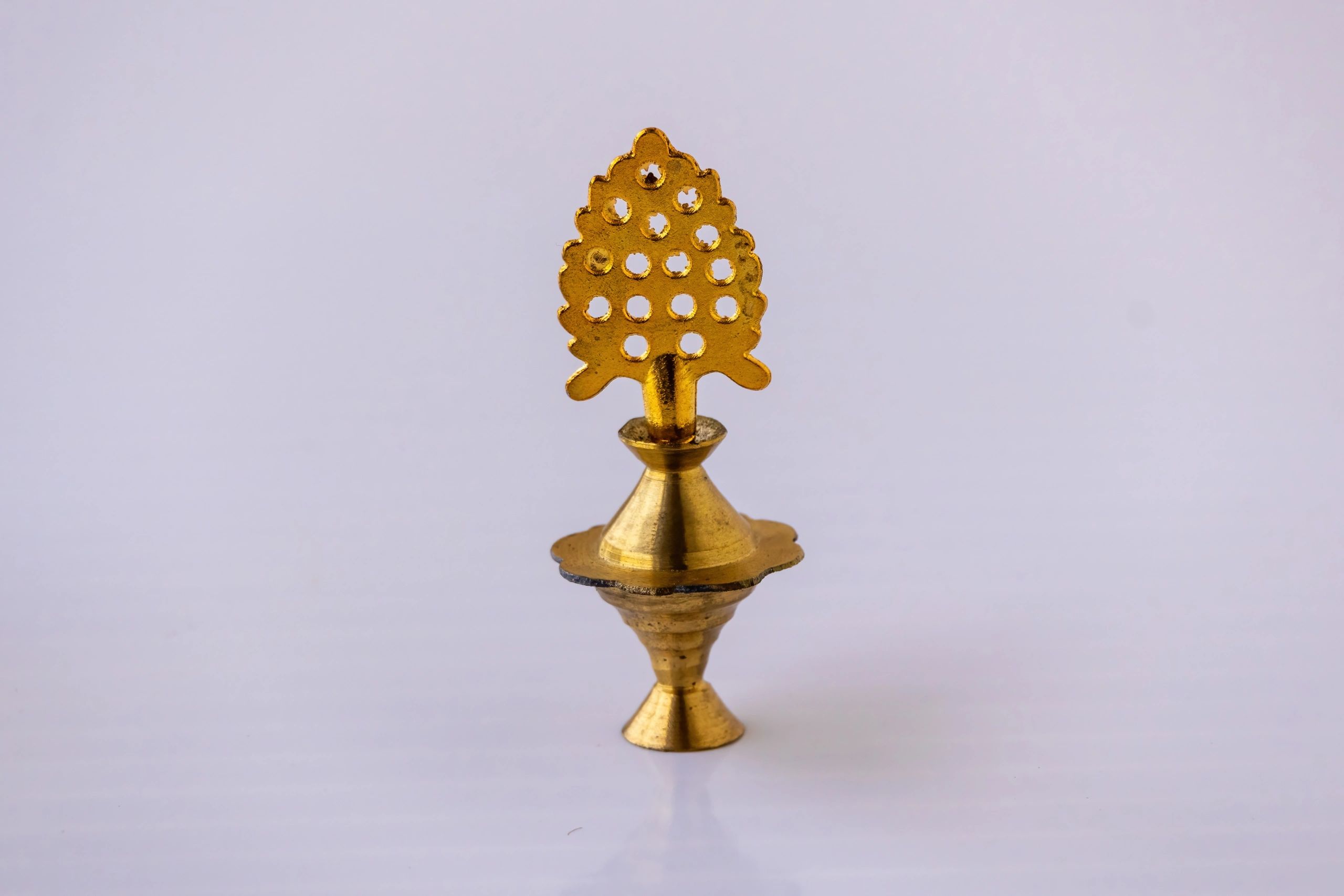Close-up of a brass decorative holder with intricate detailing