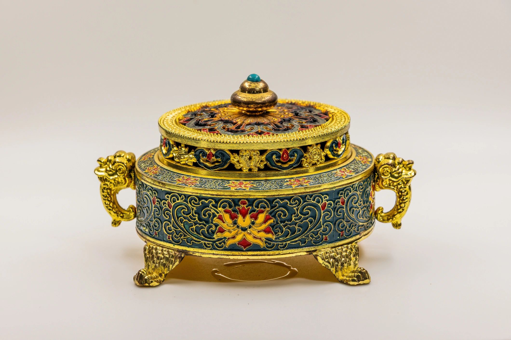 Traditional metal incense burner photographed in a studio setting